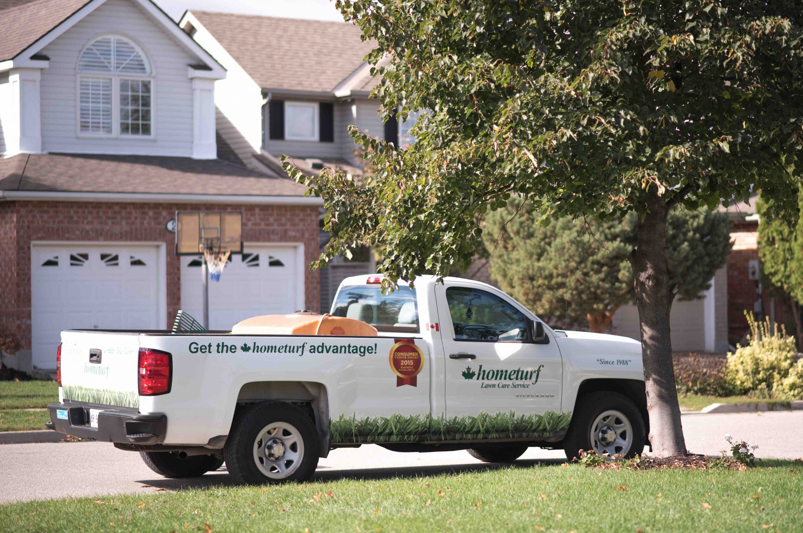 Hometurf lawn care truck parked outside a customer's property.