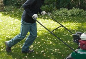 Hometurf lawn technician using a aerator machine on a customer's lawn.